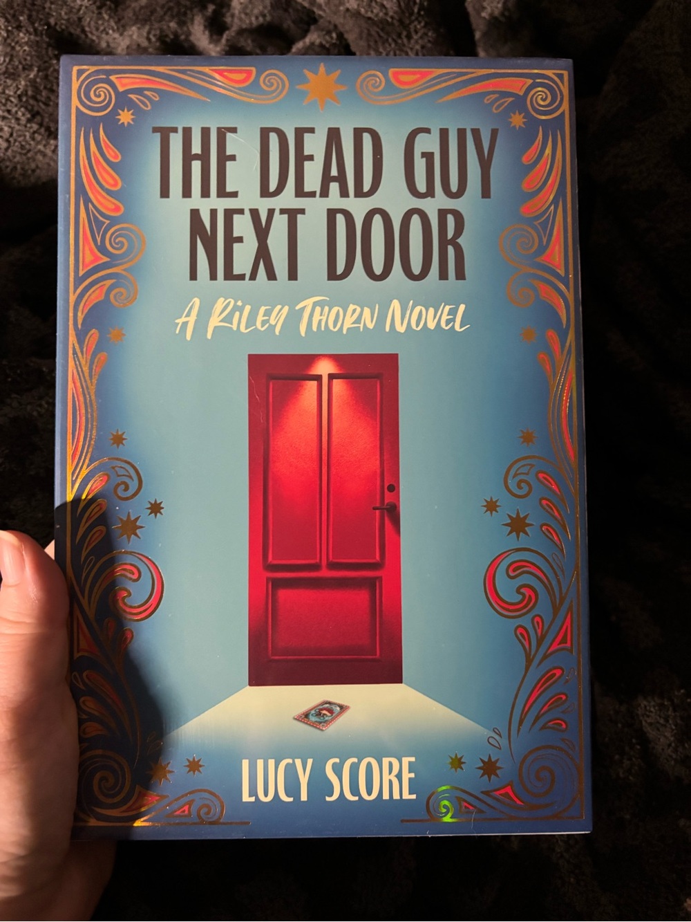 The Dead Guy Next Door by Lucy Score - Darkly Edition